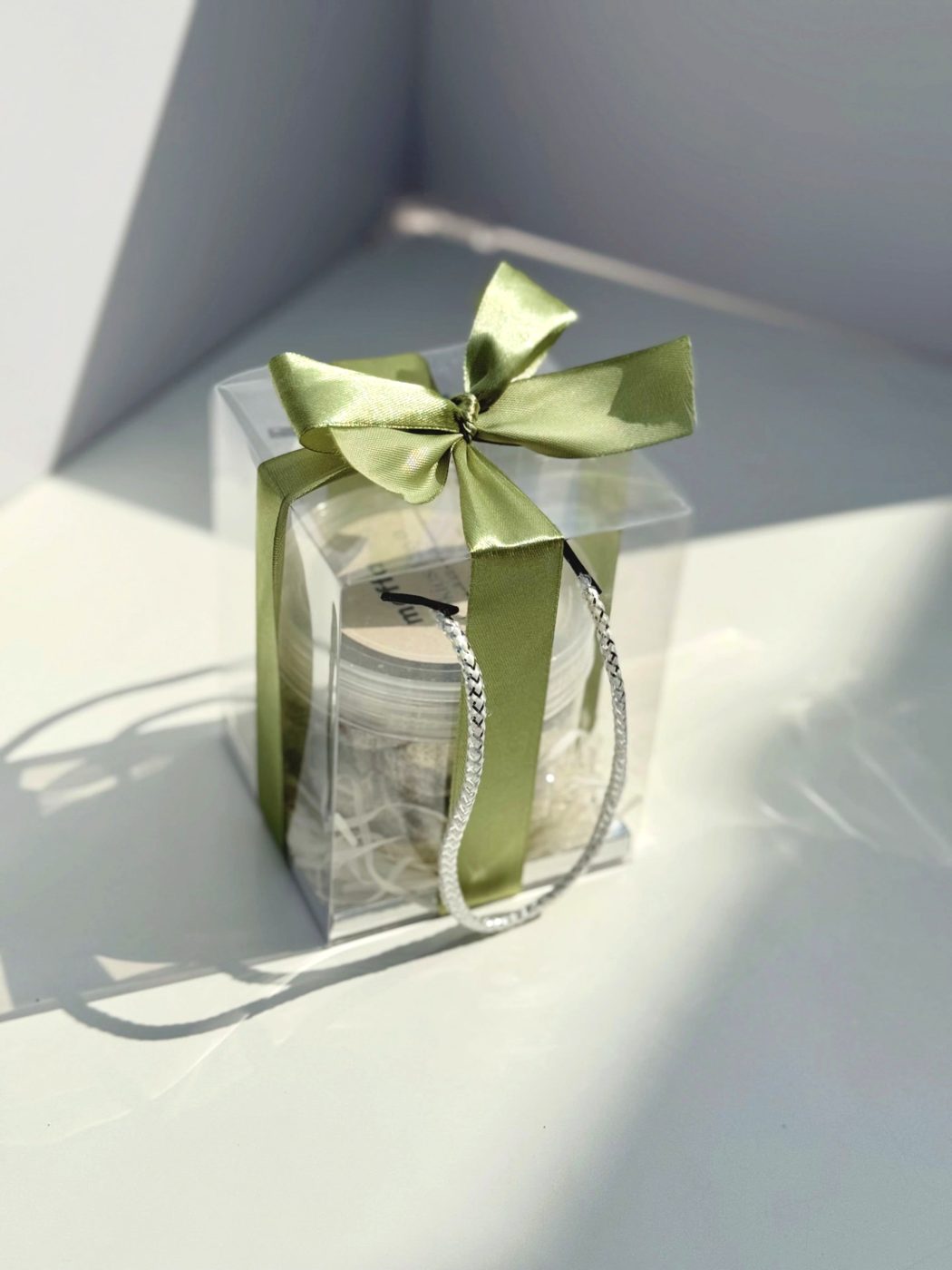 Mini cookie jar in a clear box with a sage green ribbon